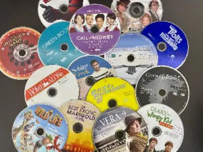 DVD's arranged in a cluster on a table.