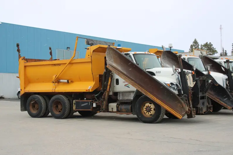 A fleet of plow trucks
