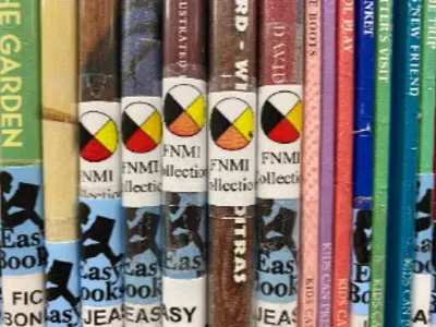 Picture book spines with stickers indicating they are Indigenous titles.