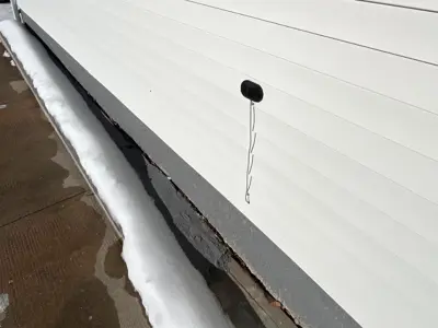 outside water-meter reading device attached to exterior wall of house