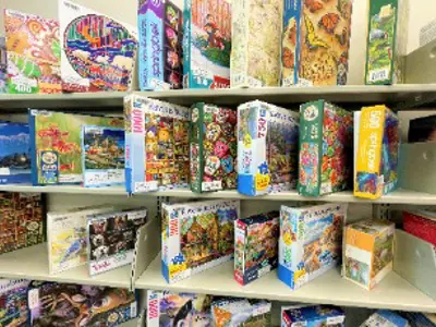 Puzzles displayed on a shelf.