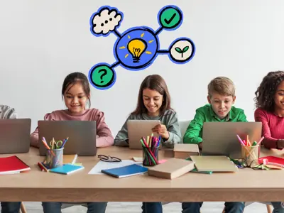 A row of children sitting at laptops.