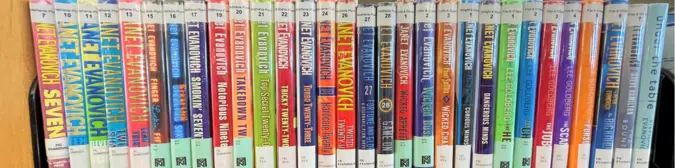 A row of Janet Evanovich books organized by series.