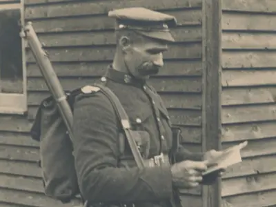 Soldier holding a letter.