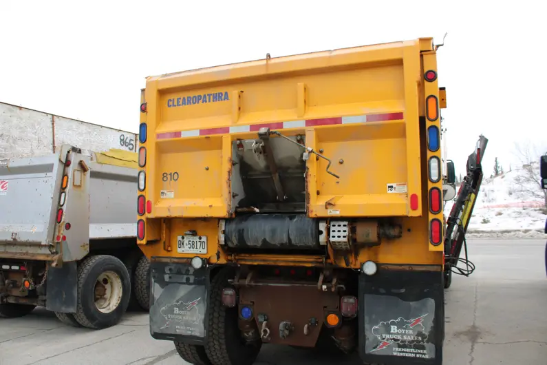 Close up view of the back of a plow truck with a decal that reads Clearopathra